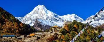 Turquoise glacial lake below snow peaks on the Manaslu circuit