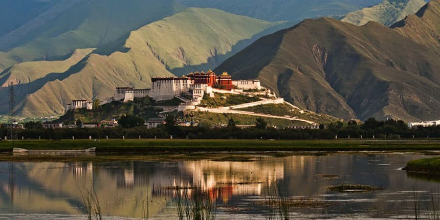 Tibetan plateau with a turquoise lake and distant peaks