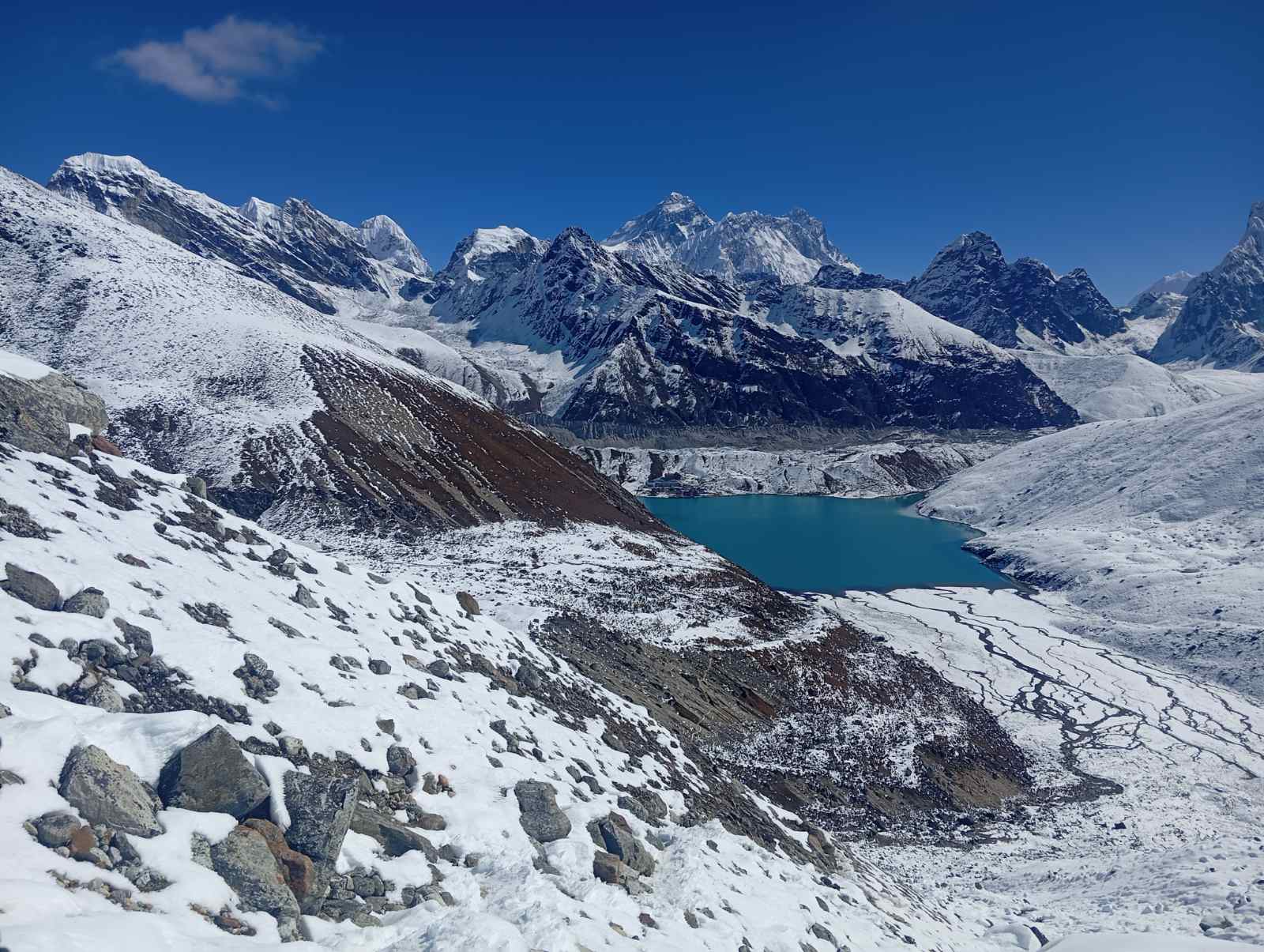 Trekkers on a snow ridge above the clouds in the Khumbu